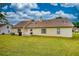 Expansive backyard features a well-maintained lawn, mature trees, and a patio area at 205 Summer Walk Dr, Covington, GA 30016