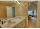Bathroom featuring double sinks and a large mirror, leading to the bedroom for convenience at 205 Summer Walk Dr, Covington, GA 30016