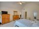 Spacious bedroom with wood furniture, vaulted ceiling, and ensuite bathroom entrance at 205 Summer Walk Dr, Covington, GA 30016