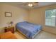 Bright bedroom with a window view, ceiling fan, and cozy interior at 205 Summer Walk Dr, Covington, GA 30016