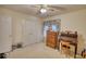Comfortable bedroom featuring double door closet, window, and desk at 205 Summer Walk Dr, Covington, GA 30016