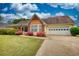 Charming one-story home with a well-manicured lawn, colorful shrubs, and an attached garage, offering curb appeal at 205 Summer Walk Dr, Covington, GA 30016