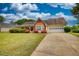Charming one-story home with a well-manicured lawn, colorful shrubs, and an attached garage, offering curb appeal at 205 Summer Walk Dr, Covington, GA 30016