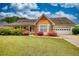 Charming one-story home with a well-manicured lawn, colorful shrubs, and an attached garage, offering curb appeal at 205 Summer Walk Dr, Covington, GA 30016