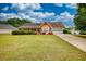 Charming home with manicured lawn, colorful flower bushes, and attached two-car garage at 205 Summer Walk Dr, Covington, GA 30016