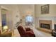 Cozy living room with a brick fireplace, comfortable seating, and view into the dining area at 205 Summer Walk Dr, Covington, GA 30016