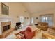 Cozy living room with a brick fireplace, comfortable seating, and natural light streaming through the windows at 205 Summer Walk Dr, Covington, GA 30016