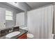 Bathroom with granite countertop vanity, white fixtures, and shower with curtain at 3452 Chesterfield Ct, Snellville, GA 30039