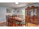 Traditional dining room featuring a wood table, upholstered chairs, and an elegant wooden china cabinet at 3452 Chesterfield Ct, Snellville, GA 30039