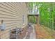 Side exterior showing a walkout deck and a brick paver patio with wood storage at 3452 Chesterfield Ct, Snellville, GA 30039