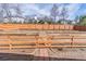 Landscaped backyard featuring tiered landscaping, wooden fencing, and access gate at 965 Mulberry Bay Dr, Dacula, GA 30019