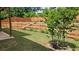 Landscaped backyard featuring lush green grass, tiered landscaping, and a covered patio at 965 Mulberry Bay Dr, Dacula, GA 30019