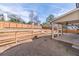 Spacious backyard featuring tiered landscaping, wooden fencing, and a covered patio area at 965 Mulberry Bay Dr, Dacula, GA 30019