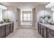 Bathroom showcasing dual vanities with granite countertops and a central tub at 965 Mulberry Bay Dr, Dacula, GA 30019