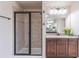 Tiled shower and vanity with granite countertop in a modern bathroom at 965 Mulberry Bay Dr, Dacula, GA 30019