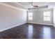 Spacious bedroom with tray ceiling, ceiling fan, and hardwood flooring at 965 Mulberry Bay Dr, Dacula, GA 30019
