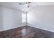 Well-lit bedroom with dark hardwood floors, light walls, and a contemporary ceiling fan at 965 Mulberry Bay Dr, Dacula, GA 30019