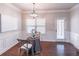 Cozy dining area featuring a decorative table setting, elegant lighting, and natural light from the window at 965 Mulberry Bay Dr, Dacula, GA 30019