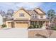 Beautiful two-story home with a three-car garage and well-maintained lawn in a suburban neighborhood at 965 Mulberry Bay Dr, Dacula, GA 30019
