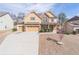 Lovely home featuring a three-car garage, manicured lawn, and inviting curb appeal at 965 Mulberry Bay Dr, Dacula, GA 30019