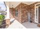 Cozy brick front porch with an inviting 'WELCOME' sign and manicured shrubs at 965 Mulberry Bay Dr, Dacula, GA 30019
