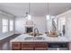 Spacious open floor plan kitchen with island, hardwood floors, fireplace, and connecting rooms at 965 Mulberry Bay Dr, Dacula, GA 30019