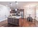 Stylish kitchen features an island with pendant lighting, stainless appliances, and a breakfast nook at 965 Mulberry Bay Dr, Dacula, GA 30019