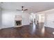 Inviting living room with dark hardwood floors, a fireplace, and an open view of the staircase at 965 Mulberry Bay Dr, Dacula, GA 30019