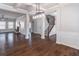 Spacious living area featuring hardwood floors, columns, and access to staircase at 965 Mulberry Bay Dr, Dacula, GA 30019