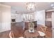 Open-concept living area features a fireplace, hardwood floors, and kitchen with island; perfect for entertaining at 965 Mulberry Bay Dr, Dacula, GA 30019