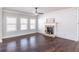 Bright living room features a shiplap accent wall with a stone fireplace and dark hardwood floors at 965 Mulberry Bay Dr, Dacula, GA 30019