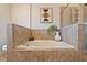 Bathroom featuring a soaking tub with tiled surround and glass enclosed shower at 1242 Morton Trce Se Trce, Atlanta, GA 30316