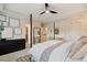 Bright bedroom featuring a ceiling fan, crib, and neutral decor with a four post bed at 1242 Morton Trce Se Trce, Atlanta, GA 30316