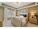 Stylish bedroom with tray ceiling, large window, and neutral color palette with matching lamps at 1242 Morton Trce Se Trce, Atlanta, GA 30316