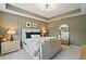 Stylish bedroom with tray ceiling, large window, and neutral color palette with matching lamps at 1242 Morton Trce Se Trce, Atlanta, GA 30316