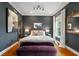 Chic bedroom featuring hardwood floors, modern lighting, and sophisticated gray walls at 1242 Morton Trce Se Trce, Atlanta, GA 30316
