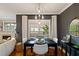 A modern dining room with sleek black table, white chairs, and stylish lighting fixtures at 1242 Morton Trce Se Trce, Atlanta, GA 30316