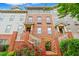 Charming three-story townhome featuring brick facade, manicured front garden, and inviting entrances at 1242 Morton Trce Se Trce, Atlanta, GA 30316