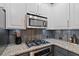 A modern kitchen features stainless steel appliances, granite countertops, and ample cabinet space at 1242 Morton Trce Se Trce, Atlanta, GA 30316