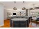 Kitchen island with pendant lighting, stone countertop, and seating in an open-concept space at 1242 Morton Trce Se Trce, Atlanta, GA 30316