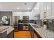 A modern kitchen featuring granite countertops, stainless steel appliances, and updated cabinetry at 1242 Morton Trce Se Trce, Atlanta, GA 30316