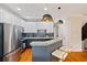 Open concept kitchen features modern cabinets, stainless appliances, granite countertops, and breakfast bar at 1242 Morton Trce Se Trce, Atlanta, GA 30316