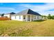 Well-maintained backyard with lush lawn and a white house exterior at 1341 Midnight Ride Ct, Hampton, GA 30228