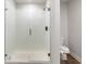 Modern bathroom showcasing a tiled stand-up shower with a glass door at 1341 Midnight Ride Ct, Hampton, GA 30228