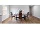 Cozy dining area with a wooden table and chairs, illuminated by natural light from a nearby window at 1341 Midnight Ride Ct, Hampton, GA 30228