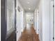 Inviting entryway with hardwood floors and white walls, leading to the kitchen at 1341 Midnight Ride Ct, Hampton, GA 30228