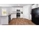 Modern kitchen featuring stainless steel appliances, granite countertops, and white cabinets at 1341 Midnight Ride Ct, Hampton, GA 30228