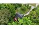 Aerial view of home nestled among lush green trees and well manicured lawn at 59 Abbotsford Dr, Villa Rica, GA 30180