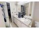 Well-lit bathroom featuring a double vanity, white cabinets, and large mirror at 59 Abbotsford Dr, Villa Rica, GA 30180