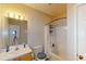 Well-lit bathroom with a shower-tub combination and an oak vanity at 59 Abbotsford Dr, Villa Rica, GA 30180